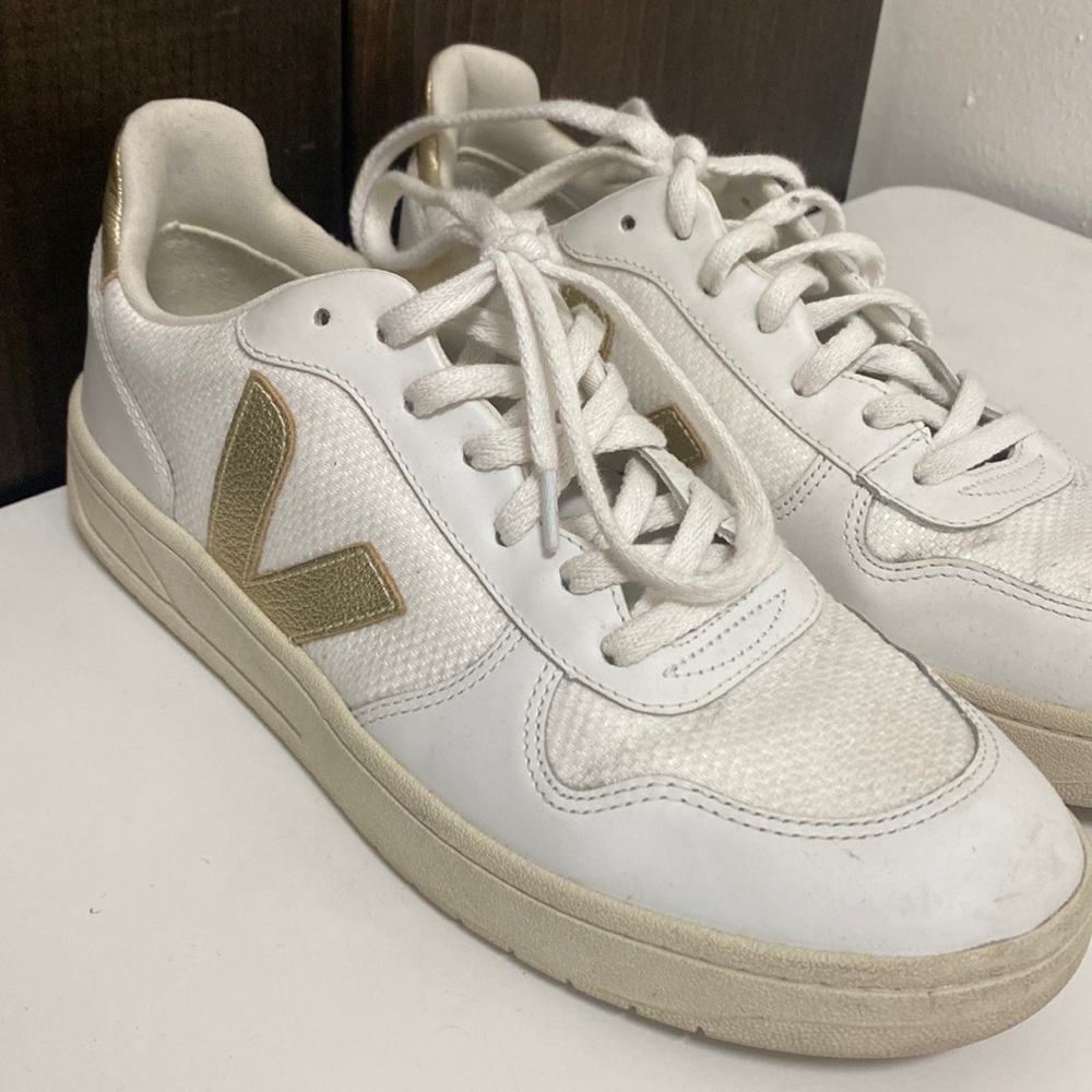 White sneakers with gold accents.